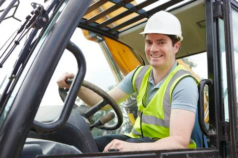 Portrait of construction worker driving digger Stock Photos