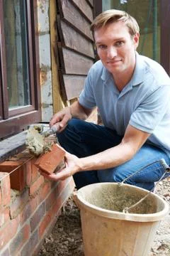 Portrait Of Construction Worker Laying Bricks Stock Photos