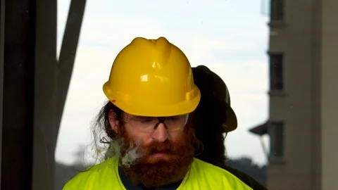 Portrait of a Construction Worker smoking in extreme slow motion outdoors Stock Footage 98090396