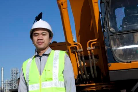 Portrait construction worker standing front of heavy equipment Foto stock