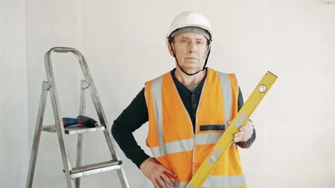 Portrait of constructor holding balance ruler and looking in camera close-up Stock Footage 169597203