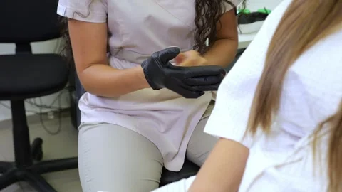 Portrait of a cosmetologist and a client in a laser depilation room. Stock Footage 321814347