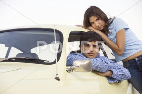 Portrait of couple by car Stock Photos