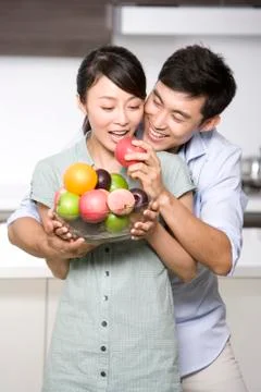 Portrait of a couple in the kitchen Stock Photos