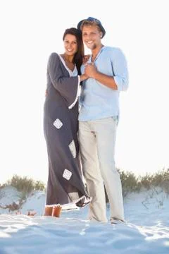 Portrait of a couple standing on the beach Stock Photos