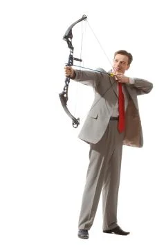 Portrait of courageous businessman holding crossbow and aiming at target Фото