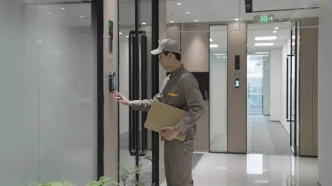 Portrait of courier with postal package parcel cardboard box to a contemporary Stock Footage 331292443