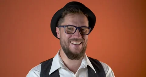 Portrait of crazy bearded man in stylish glasses and funny hat Stock Footage 131405507