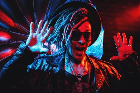 Portrait of a crazy disco man with dreadlocks. Party, disco. Colorful light. Stock Photos