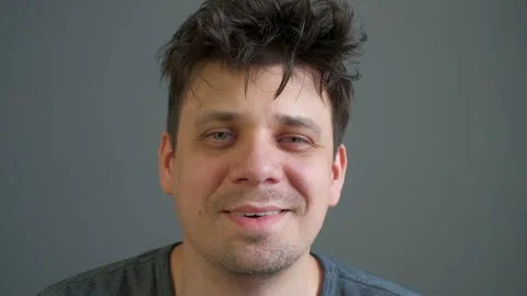 Portrait of crazy laughter of a drunk or drugged young man looking at camera. Stock Footage 158923873
