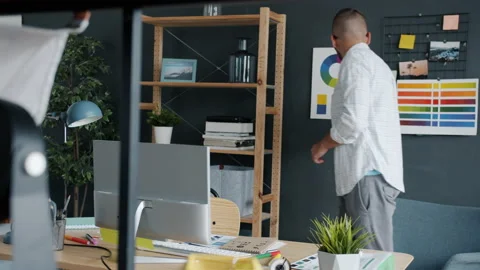 Portrait of creative guy designing logo for smartphone app choosing colors Stock Footage 158097327