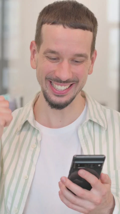 Portrait of Creative Young Man Talking on phone, vertical video Stock Footage 325564425