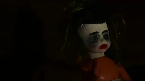 Portrait of a creepy doll in the sliding light of a lantern Stock Footage 139694341