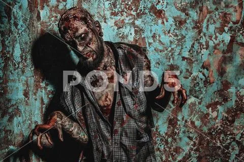 A portrait of a creepy scary zombie. Halloween. Horror film. Stock Photos