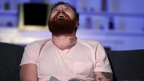Portrait of crying bearded man watching sad film at home. Stock-Footage 122598408