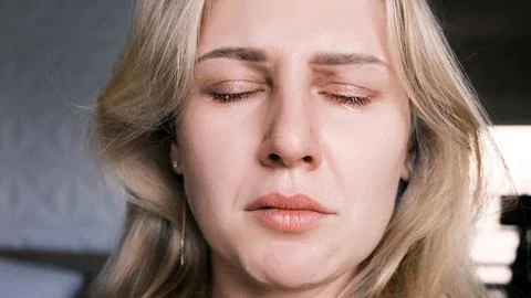 Portrait of crying grieving woman of 30 years. Grimace of sadness with tears in Stock Photos