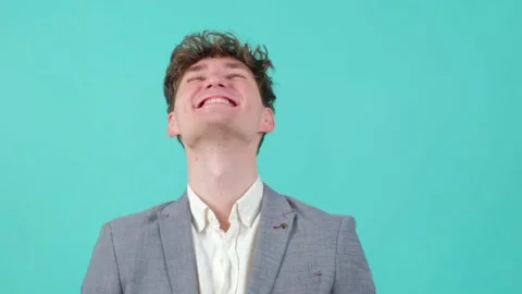 Portrait of culy haired handsome young man that is smiling over turquoise 스톡 동영상 151286498