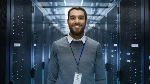 Portrait of a Curios, Positive and Smiling IT Engineer Standing in the Middle Stock Photos