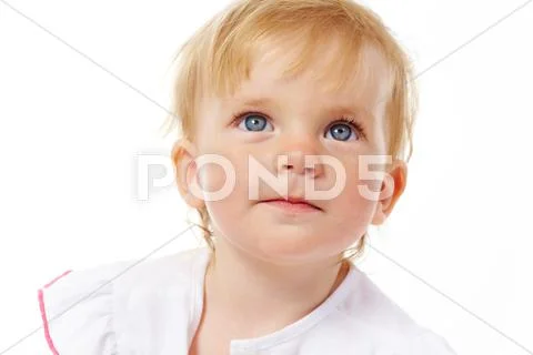 Portrait of curious child looking upwards over white background Stock Photos