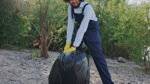Portrait of Curly Charismatic Activist in Work. Male Collect Garbage. Volunteer Stock Footage 148186830