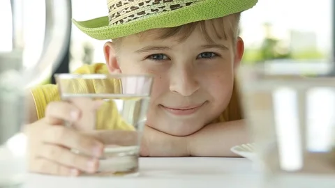  Portrait of cut  child smiling drinking water at home. Stock Footage 108541973