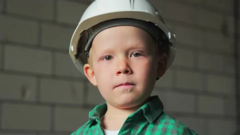 A portrait of a cute 5 year old boy in a white helmet and a green plaid shirt Video stock 238091072