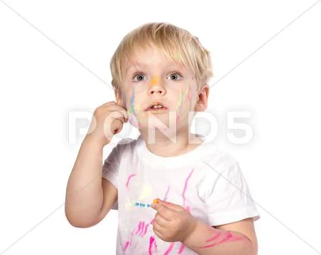 Portrait of a cute blond boy enjoying her painting. Stock Photos