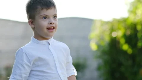 Portrait of a cute boy with disabilities, Down syndrome Stock Footage 165042729