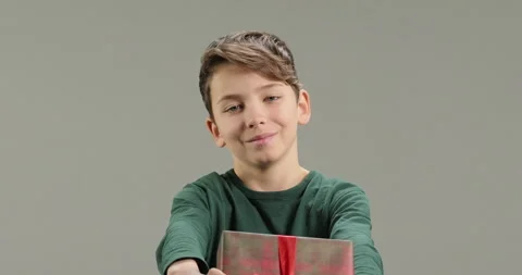 Portrait of cute boy giving gift box present at camera. Happy Mothers Day Stock Footage 261577568