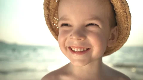Portrait cute boy in a straw hat on the beach Stock Footage 106036360
