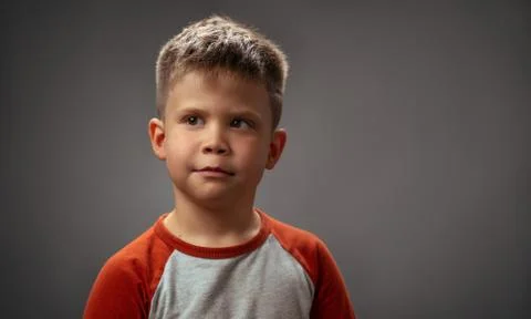 Portrait of a cute boy in the studio. Brooding look up. High quality photo Stock Photos