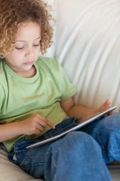 Portrait of a cute boy using a tablet computer 写真素材