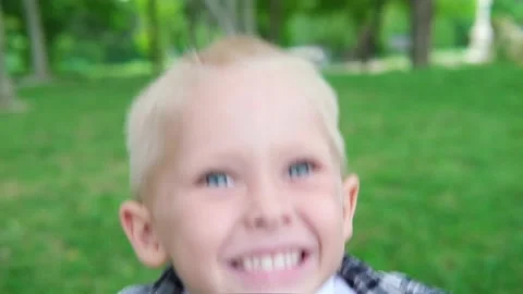 Portrait of cute caucasian blond little preschooler boy jumping on the grass and Stock Footage 165181853