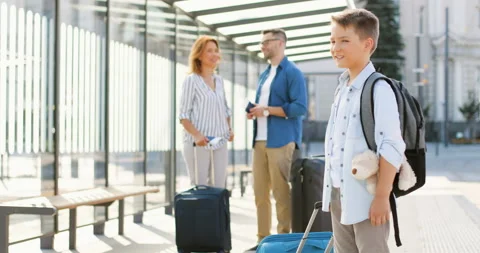 Portrait of cute Caucasian small boy with backpack, teddy bear toy and suitcase Video stock 135902205