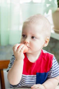 Portrait of a cute child with Easter eggs. Easter lunch. The feast of Holy Ea Stock Photos