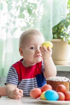Portrait of a cute child with Easter eggs. Easter lunch. The feast of Holy Ea Stock Photos
