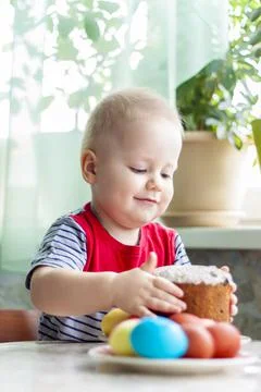 Portrait of a cute child with Easter eggs. Easter lunch. The feast of Holy Ea Stock Photos