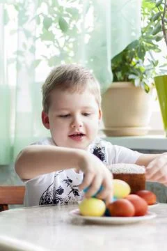 Portrait of a cute child with Easter eggs. Easter lunch. The feast of Holy Ea Stock Photos