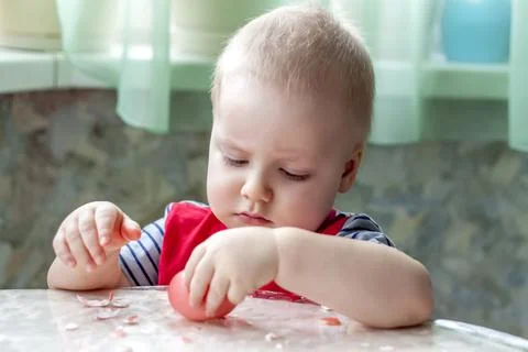 Portrait of a cute child with Easter eggs. Easter lunch. The feast of Holy Ea Stock Photos