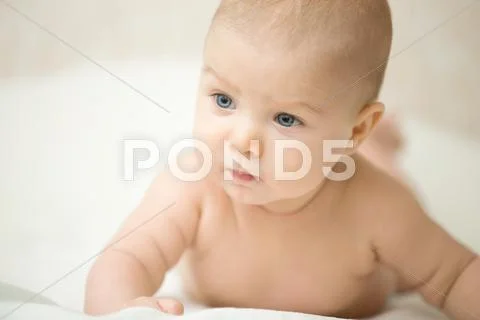 Portrait of a cute child turnig his head, looking serious Stock Photos