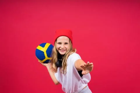Portrait of a cute eight year old girl in volleyball outfit isolated on red Stock Photos