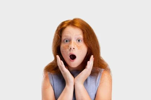 Portrait of cute freckled red-headed girl in casual outfit posing isolated on Stock Photos