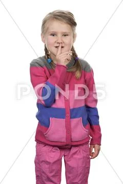 Portrait of cute girl with silence gesture Stock Photos