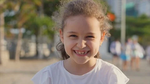 Portrait Cute Little Child smilling on the Sunset in City Park . Stock Footage. Stock Footage