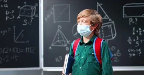 Portrait of cute red-haired small Caucasian boy in medical mask and with Stock Footage 138457888