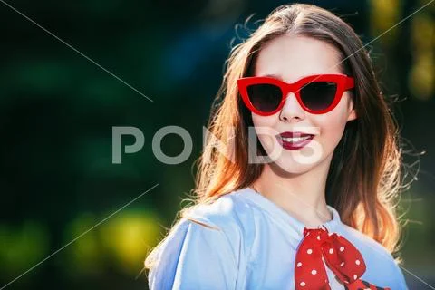 A portrait of a cute romantic girl walking in the park. Summer casual fashion Stock Photos