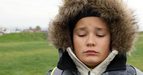 Portrait of a cute sad winter boy Video stock 100648963