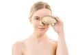 The portrait of the cute woman with an avocado on the white background Photo
