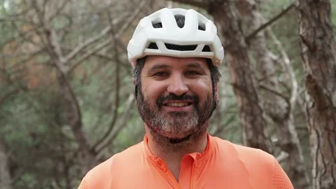 Portrait of cyclist man looking at camera smiling in the forest. Stock Footage 243569051