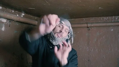 Portrait of an dancing evil terrorist with a knife in his hands Video stock 82539067